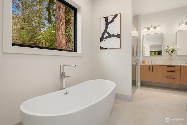 bathroom with vanity, tile patterned flooring, and a bathing tub