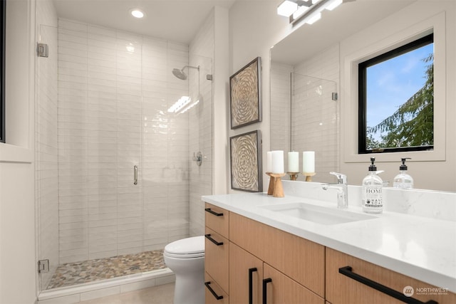 bathroom featuring vanity, toilet, and an enclosed shower