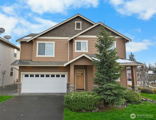 craftsman house with a garage and driveway