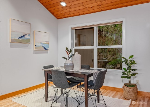 dining room featuring vaulted ceiling, wood ceiling, and hardwood / wood-style floors