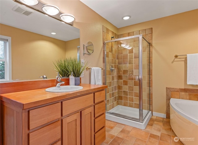 bathroom featuring plus walk in shower and vanity