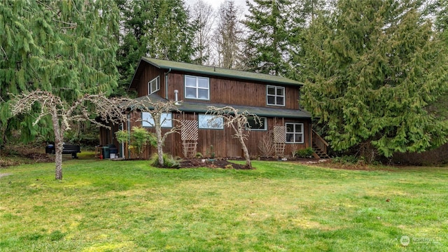 rear view of property with a yard