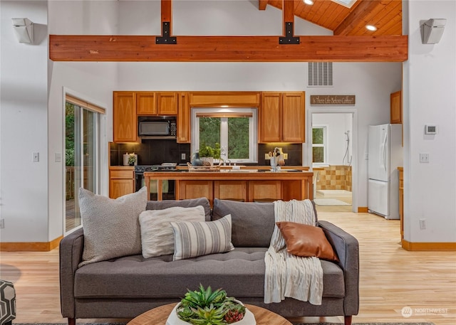 living room with high vaulted ceiling, a healthy amount of sunlight, and wooden ceiling