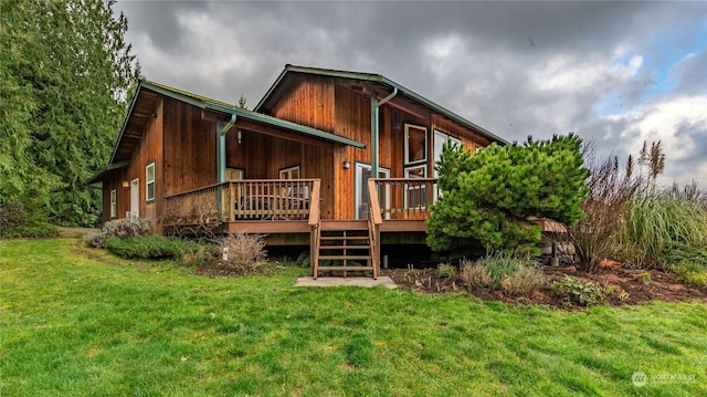 back of house with a wooden deck and a yard