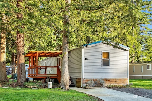 view of side of home featuring a deck and a yard