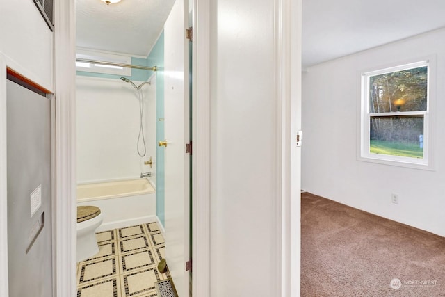 bathroom with toilet and shower / bathing tub combination