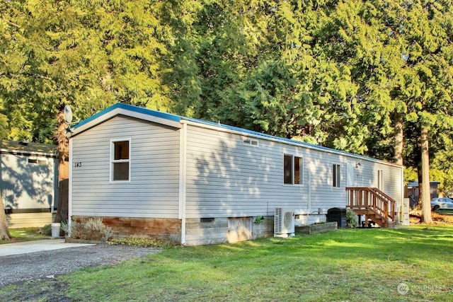 exterior space featuring ac unit and a yard