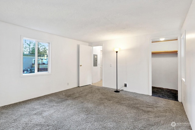 carpeted empty room with electric panel