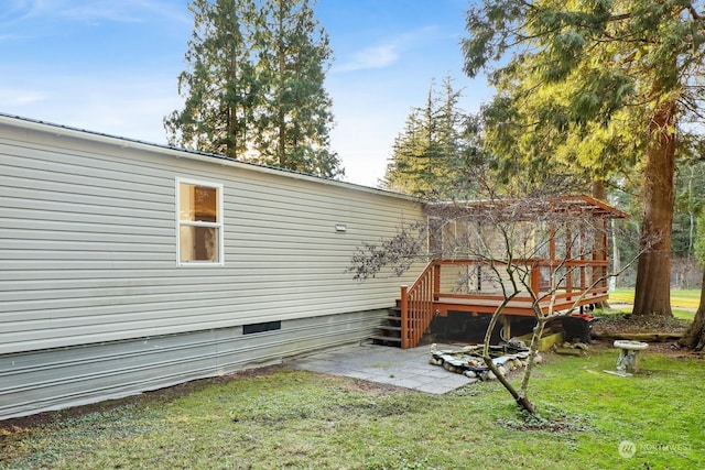 back of house featuring a deck and a yard