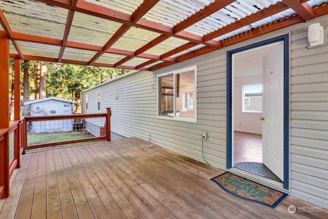 wooden deck featuring a shed