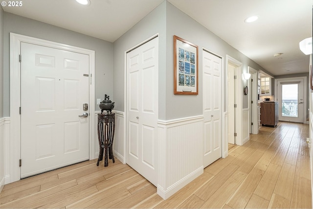 foyer entrance with light hardwood / wood-style floors