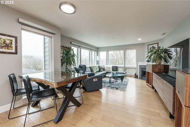 dining space with light hardwood / wood-style flooring