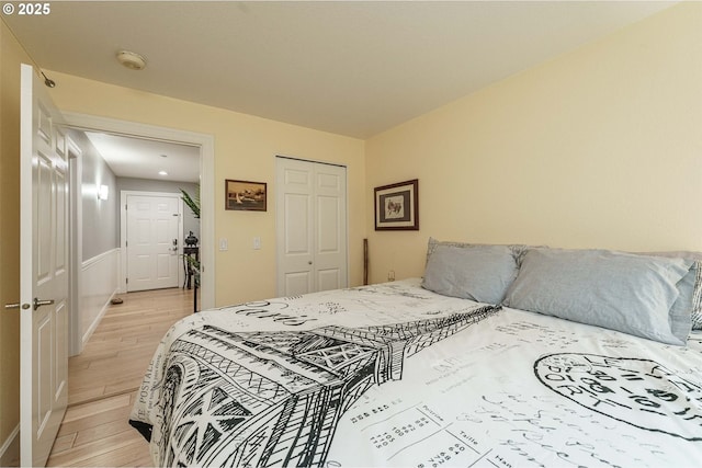 bedroom with light wood-type flooring and a closet