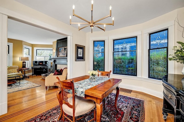 dining space with a notable chandelier and hardwood / wood-style floors