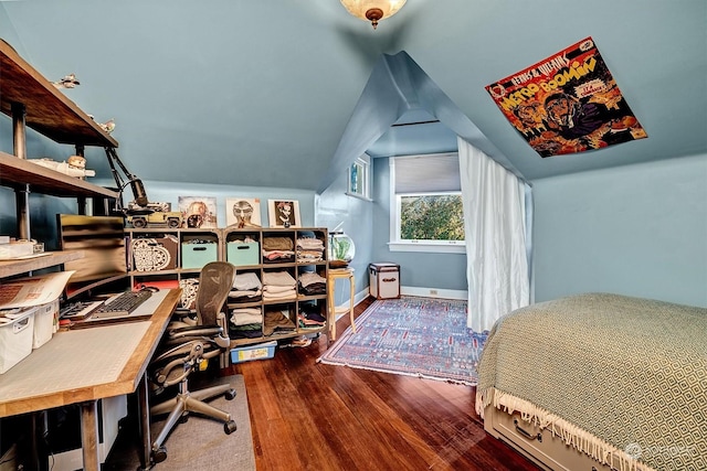 bedroom featuring hardwood / wood-style floors and lofted ceiling