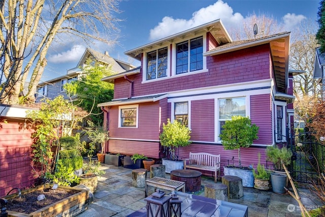 rear view of house featuring an outdoor fire pit and a patio