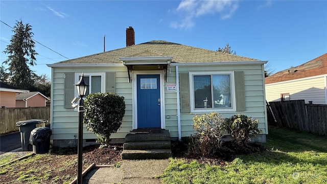 bungalow-style house with a front lawn