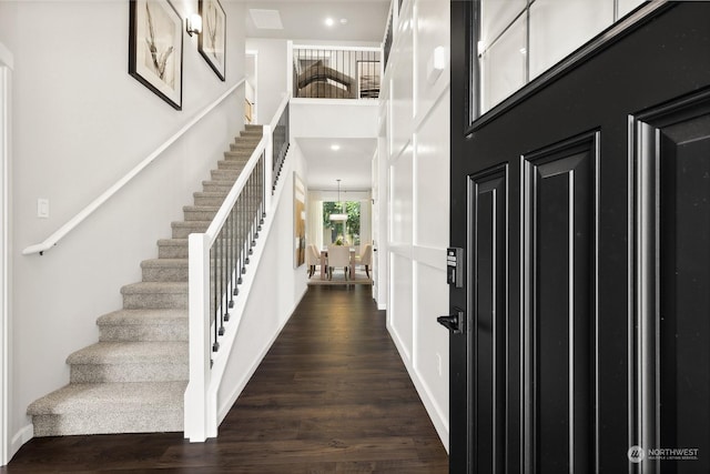 entrance foyer featuring dark hardwood / wood-style floors and a high ceiling