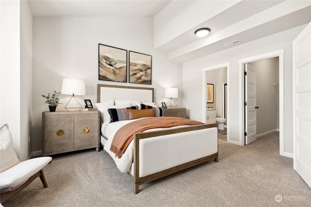 carpeted bedroom featuring lofted ceiling and connected bathroom