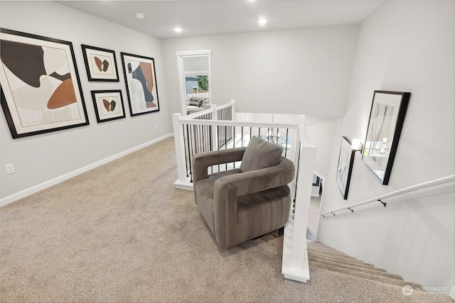 living area with light colored carpet