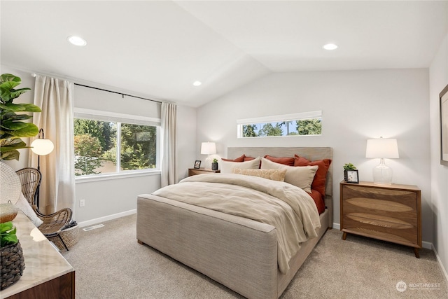 bedroom featuring light carpet and vaulted ceiling