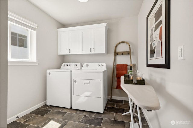 laundry room featuring cabinets and washing machine and dryer