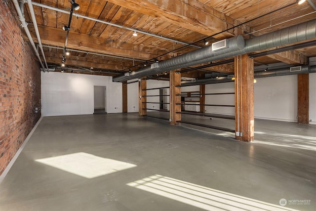 basement featuring brick wall