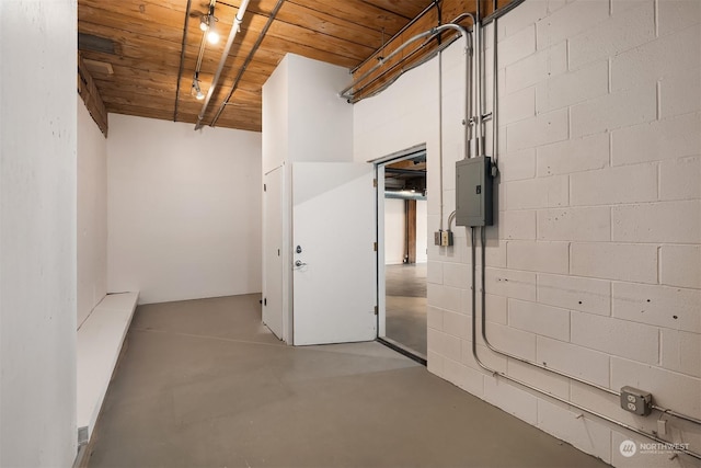 basement featuring electric panel and wood ceiling