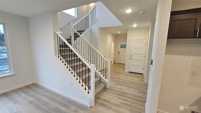 stairway featuring recessed lighting, baseboards, and wood finished floors