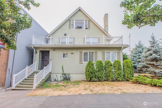 view of front of house featuring a balcony