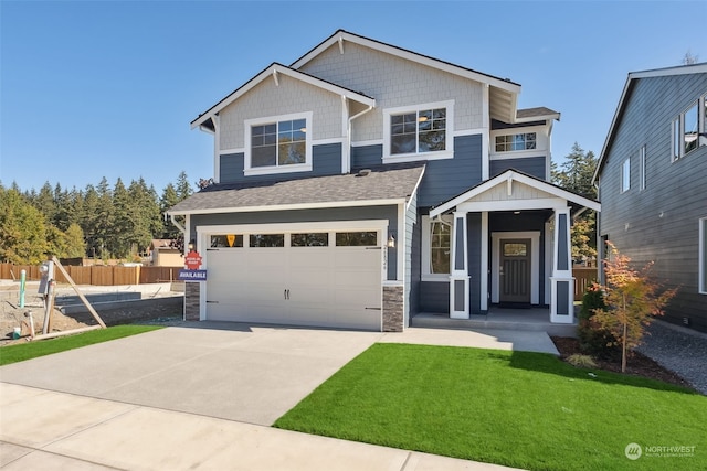 craftsman-style home with a garage and a front lawn