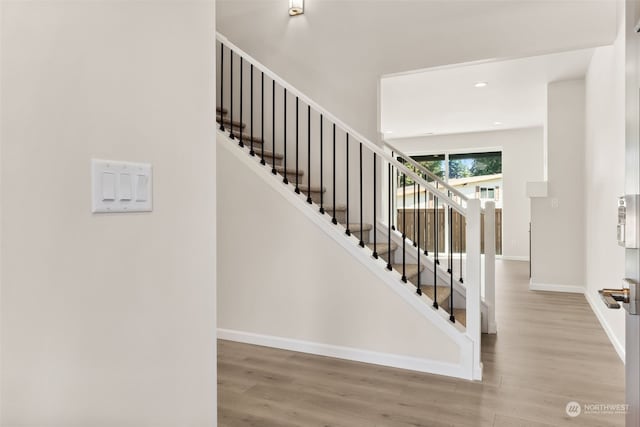 stairs featuring wood-type flooring