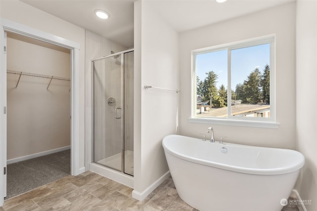 bathroom featuring shower with separate bathtub