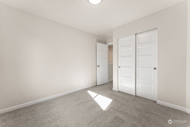 unfurnished bedroom with a closet and carpet flooring