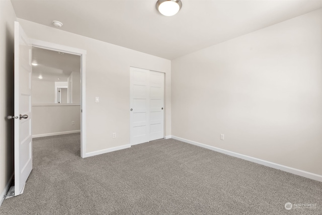 unfurnished bedroom with carpet floors and a closet