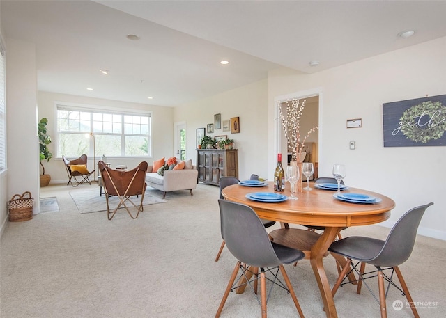 dining space featuring light colored carpet