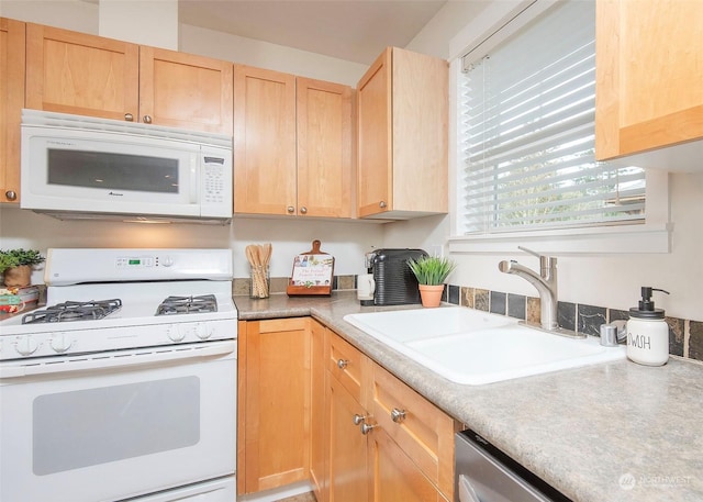 kitchen featuring light brown cabinets, sink, and white appliances