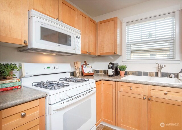 kitchen featuring sink and white appliances