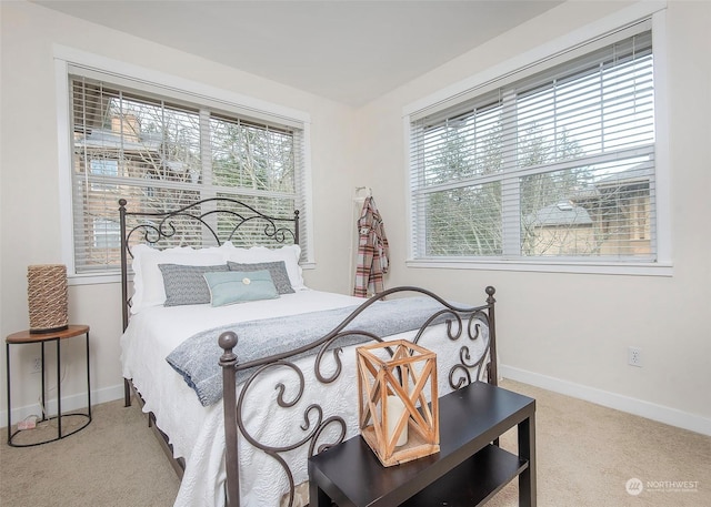 carpeted bedroom with multiple windows