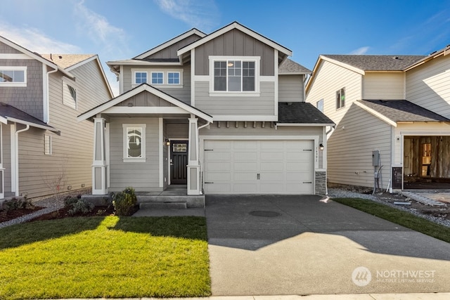 view of front of property featuring a front lawn, a garage, board and batten siding, and driveway