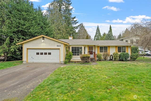 ranch-style home featuring a garage and a front yard