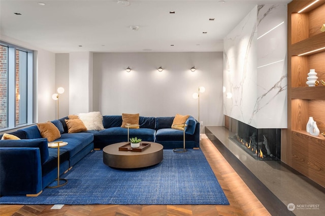 living room featuring parquet flooring and a fireplace