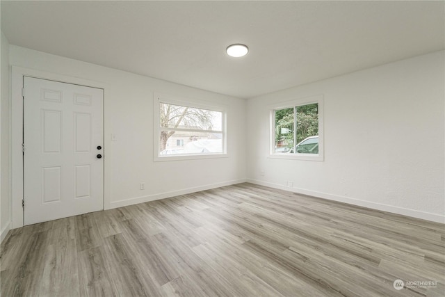 unfurnished room with light hardwood / wood-style flooring