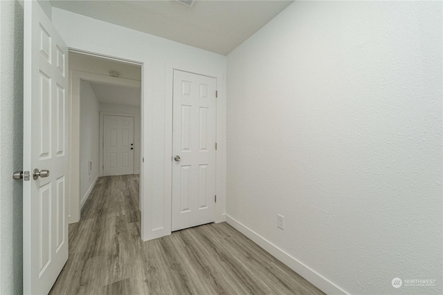 corridor featuring light hardwood / wood-style flooring