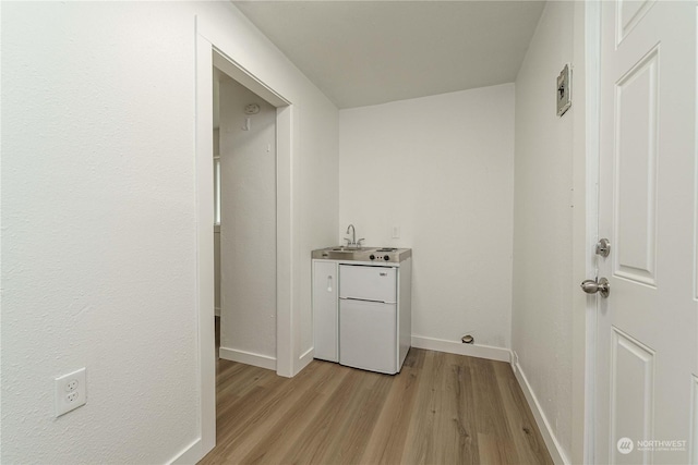 washroom featuring light hardwood / wood-style flooring and sink