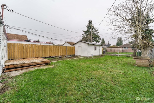 view of yard with a wooden deck and a storage shed