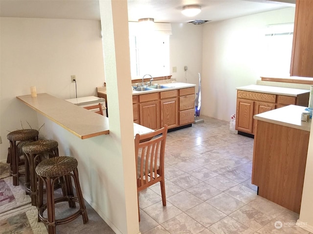 kitchen featuring sink and a breakfast bar