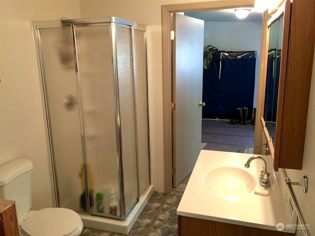 bathroom with vanity, toilet, and walk in shower