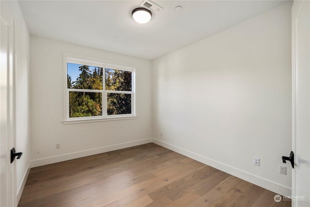 unfurnished room featuring hardwood / wood-style floors