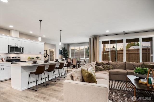 living room featuring recessed lighting and light wood finished floors